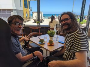 Darryl and Ferg having a coffee at the beach