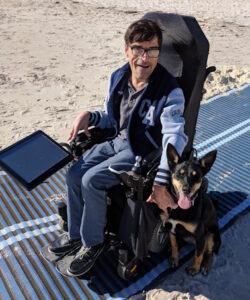 Darryl and Ziva on the beach wheelchair mat